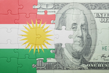 puzzle with the national flag of kurdistan and dollar banknote