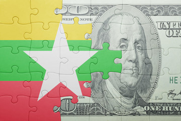puzzle with the national flag of myanmar and dollar banknote