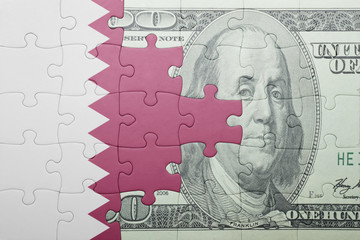 puzzle with the national flag of qatar and dollar banknote