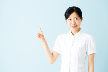 portrait of asian nurse isolated on blue background