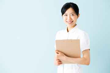 portrait of asian nurse isolated on blue background