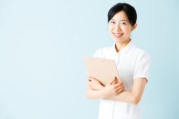Obraz premium portrait of asian nurse isolated on blue background