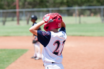 Young american baseball boy on base