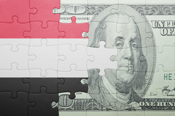 puzzle with the national flag of yemen and dollar banknote
