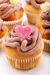 Valentine muffin with pink heart on white background