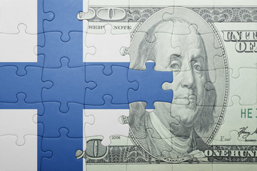puzzle with the national flag of finland and dollar banknote