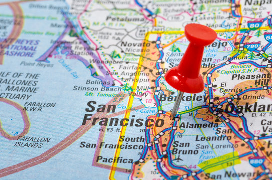 Red Pushpin highligting San Francisco on a Road Atlas
