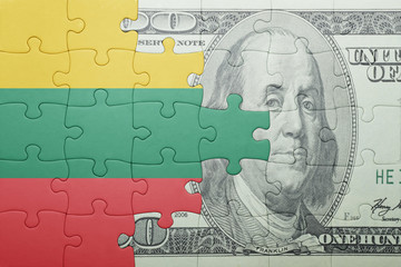 puzzle with the national flag of lithuania and dollar banknote