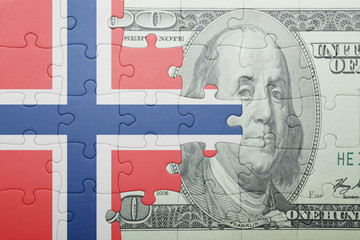 puzzle with the national flag of norway and dollar banknote