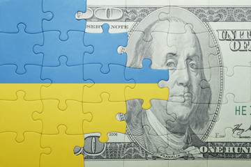 puzzle with the national flag of ukraine and dollar banknote