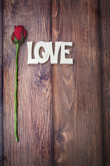 love and rose on wood table background