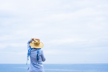 Woman standing against the sea