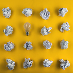 Crumpled paper balls and blank sheet of paper with pencil on yellow background. Paper wad. Creativity problems. Searching ideas.