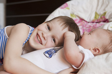 Dreaming newborn baby and 5 years old brother