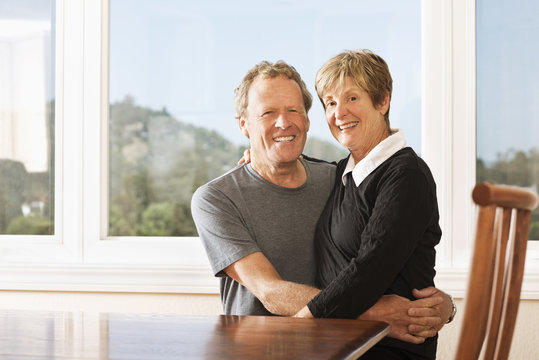 Caucasian couple smiling together at kitchen table