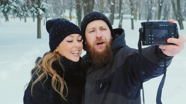 Attractive couple doing selfie in winter