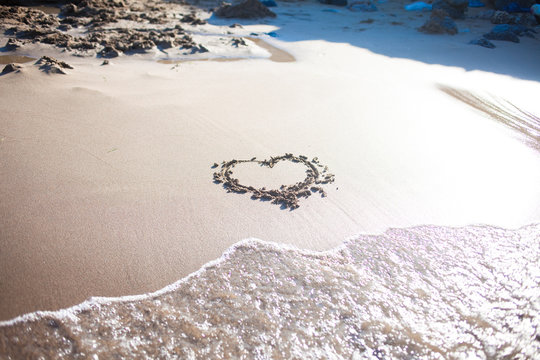heart in sand at the beach, confession of love, summer, sea and sun