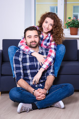 Fototapeta na wymiar portrait of beautiful couple sitting on sofa