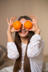 Pretty brunette girl with oranges