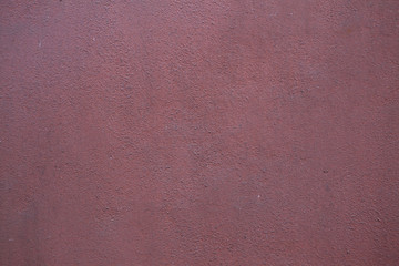 Fototapeta premium Burgundy red painted stucco wall. Background texture