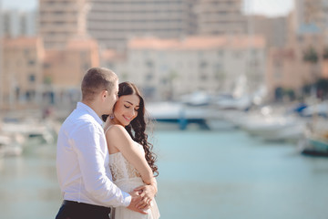 Fototapeta na wymiar Happy loving couple on sunny marina outdoors background