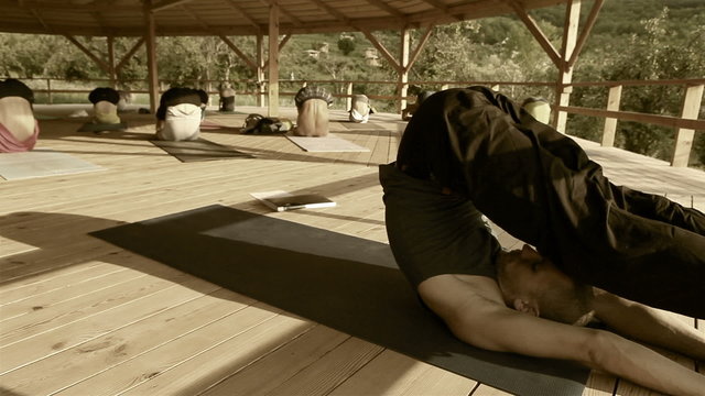 Toned footage of a yoga trainer conducting seminar