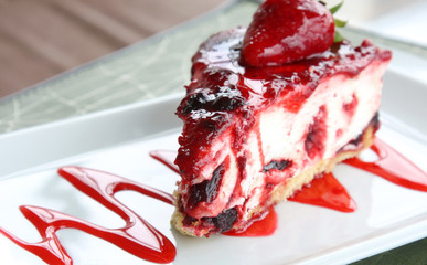 served on white plate slice of delicious strawberry and berry cheese cake