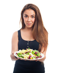 portrait of a young woman holding a fresh salad