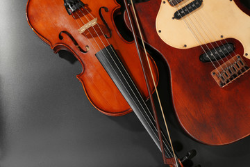 Electric guitar and violin on grey background