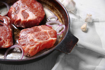 Marbled beef steak on pan and spices on color wooden background