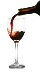 Red wine pouring in glass, isolated on white