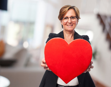 Portrait Of A Mature Business Woman Holding A Heart