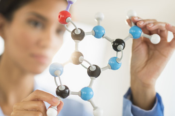 Hispanic scientist examining molecular model