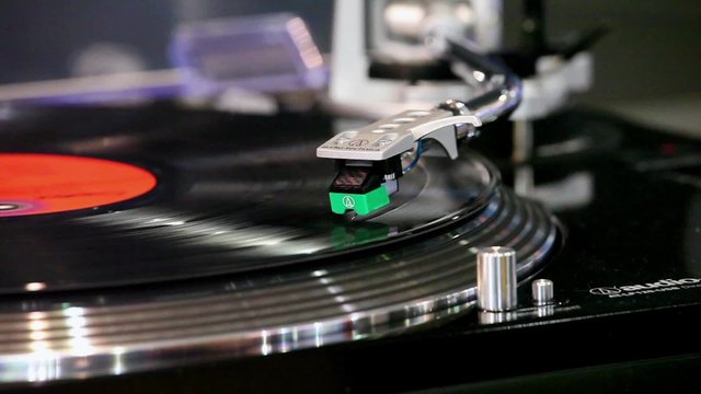Close up of a record player playing vinyl. Retro Vinyl Turntable Stylus 