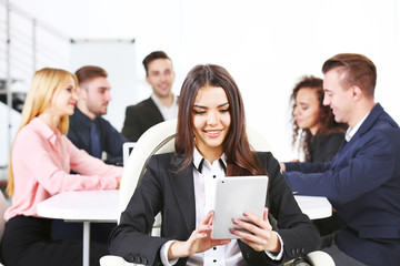 Photo of business woman with her staff in conference room at the meeting