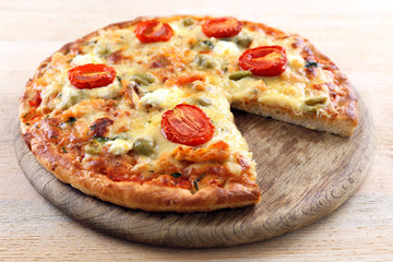 Delicious tasty pizza with cut slice, closeup