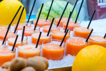 Delicious sweet cocktails and fresh fruits in the shop with takeaway