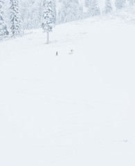 Fototapeta na wymiar scenic view of small people walking in snow mountain.