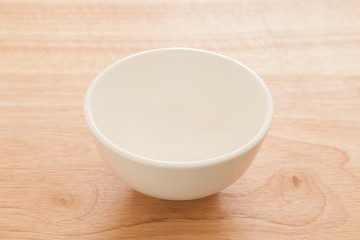 Empty bowl on a wooden board