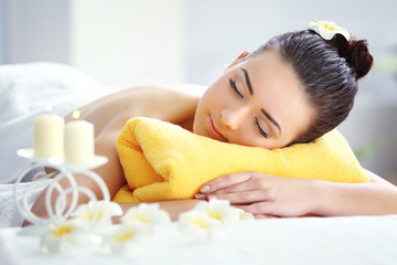 Young beautiful woman relaxing in salon, close up. Spa concept