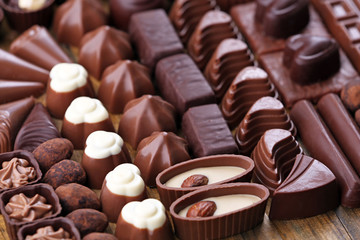 Assortment of delicious chocolate candies background, close up