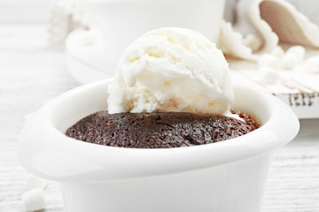 Chocolate lava cake with ice-cream in a bowl, close-up
