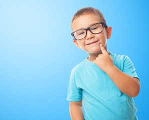 portrait of a little boy with think gesture