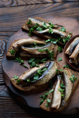 Sandwiches with smoked sprats and fresh chopped parsley