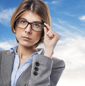 Portrait Of An Executive Young Woman Putting On Her Glasses