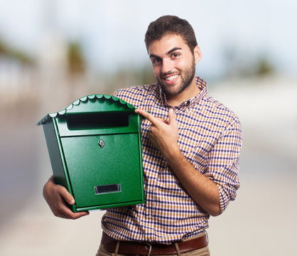 A handsome young man holding a malbox