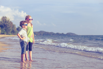 Happy children playing on the beach at the day time.