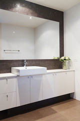 Clean white bathroom with mosaic rustic splashback