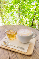 Cup of coffee latte art on wood table abstract blur background,
