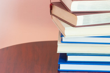 books stack over abstract wood background